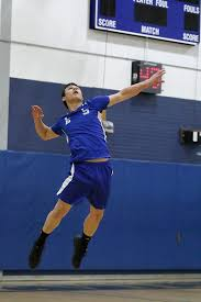 Leominster High School senior Eric Jenny serves
the ball at the game against South Lancaster.
