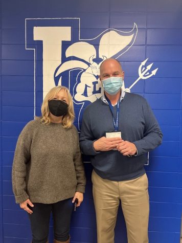 Principal Steven Dubzinski (right) proudly holds his Covid vaccine card. The school continues to encourage all eligible students and staff to be vaccinated. 