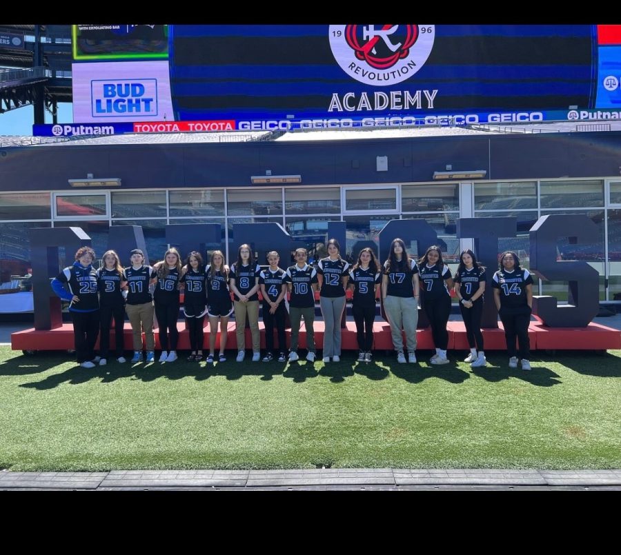 The inaugural LHS Girls Flag Football team pose for a team photo at Gillette Stadium. 