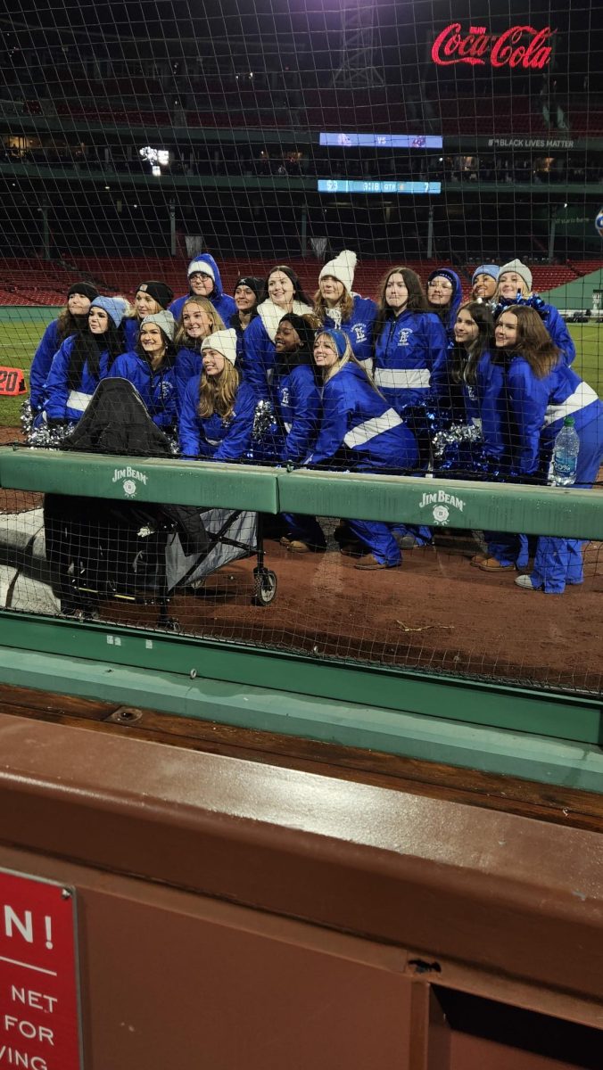 The State Champion Leominster Blue Devil Game Day Cheerleaders pose on Fenway Park during the Thanksgiving Game. 