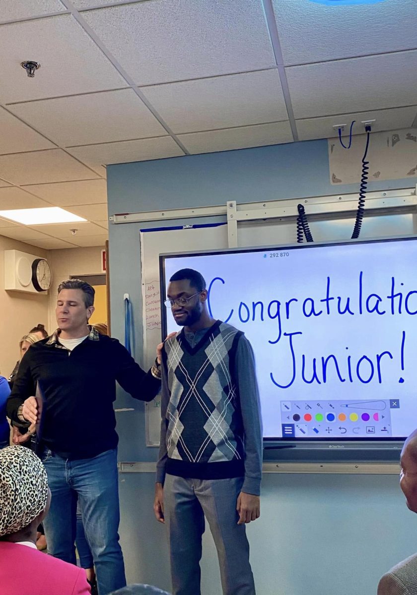 Junior Brevette is congratulated by LHS Principal Dr Josh Romano