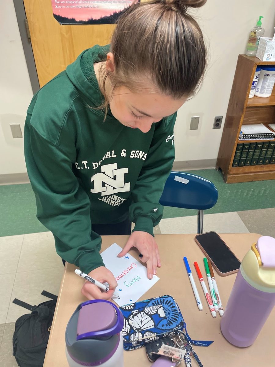 LHS Senior Adriana Buteyn coloring in Christmas card during the Health Club meeting. 
