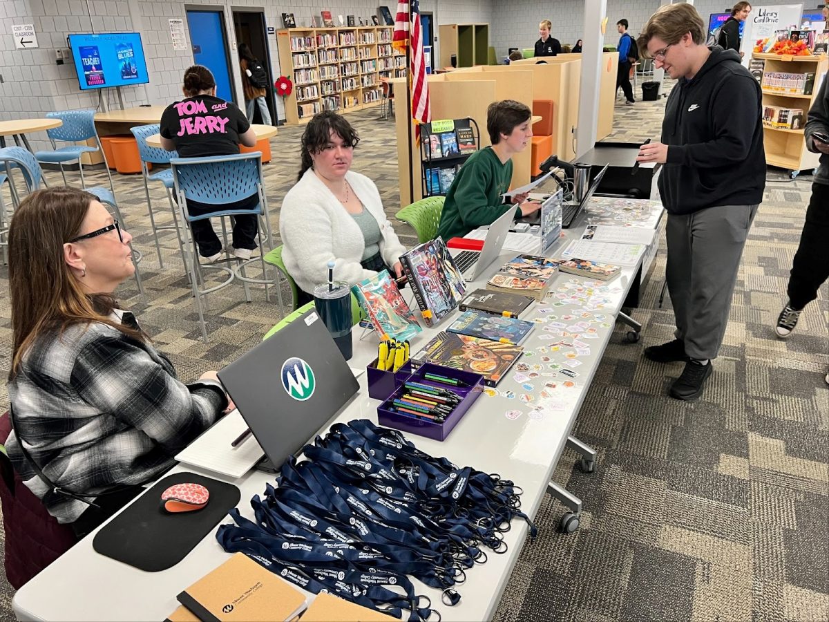 Librarians from the Public Library sign up students for a new library card in the LHS Media Center. 