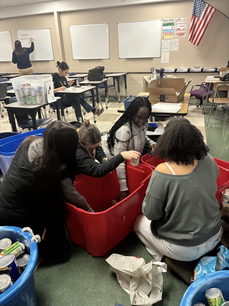 Student Council senior students organizing the bins after the annual food drive. From left: Camila Correa, Chloe Bisceglia, Princess Sasu, and Alexa Jah 