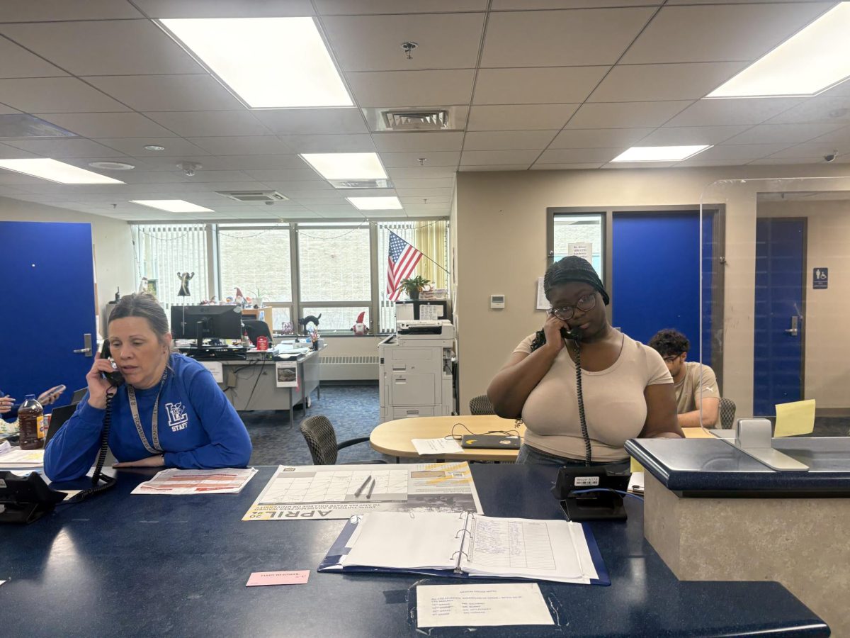 LHS secretary (left) and LHS Senior Nana Aning Sarpong are busy working in the Main Office. 